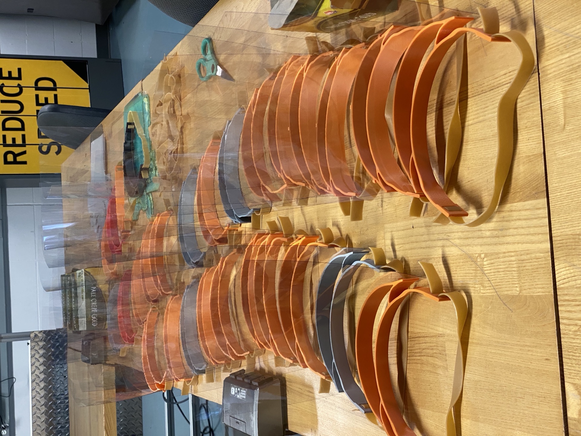Assembled face shields stacked on the lab workbench